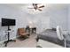 Cozy bedroom featuring a ceiling fan, desk area, and neutral color palette at 7237 Edmund Ct, Mount Dora, FL 32757