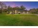 Charming single-story home featuring a lush lawn, well-manicured landscaping, and a welcoming front entrance at 7237 Edmund Ct, Mount Dora, FL 32757