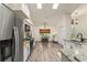 Bright kitchen featuring stainless steel appliances, granite countertops, and eat-in nook with natural light at 7237 Edmund Ct, Mount Dora, FL 32757