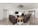 Cozy living room featuring hardwood floors, a fireplace, and comfortable seating arrangement at 7237 Edmund Ct, Mount Dora, FL 32757