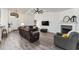 Bright living room with hardwood floors, high ceilings, ceiling fan, recessed lighting, and comfortable seating at 7237 Edmund Ct, Mount Dora, FL 32757
