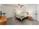 Bright main bedroom with a ceiling fan, wood-look floors, and an ensuite bathroom entrance at 7237 Edmund Ct, Mount Dora, FL 32757
