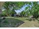 Lush backyard featuring a utility shed, a small storage building, and mature trees at 7727 Arezzo Ave, Orlando, FL 32819