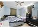Cozy bedroom features tile floors, a ceiling fan, and natural light streaming in from the window, creating a peaceful ambiance at 7727 Arezzo Ave, Orlando, FL 32819