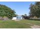 Charming blue one-story home featuring a well-maintained lawn and fenced-in yard at 7727 Arezzo Ave, Orlando, FL 32819