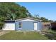 Charming one-story home with blue exterior and a well-maintained, fenced yard, creating a cozy and inviting curb appeal at 7727 Arezzo Ave, Orlando, FL 32819
