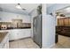 Kitchen featuring white cabinets, mosaic backsplash, stainless steel appliances, and ample counter space at 7727 Arezzo Ave, Orlando, FL 32819