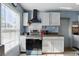 Well-lit kitchen with white cabinets, stainless steel appliances, and a window that floods the space with natural light at 7727 Arezzo Ave, Orlando, FL 32819