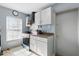 Well-lit kitchen with white cabinets, stainless steel appliances, and a window that floods the space with natural light at 7727 Arezzo Ave, Orlando, FL 32819