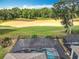 Scenic aerial view showcasing the pool, golf course, and serene backyard setting at 7748 Four Seasons Blvd, Kissimmee, FL 34747