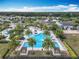 Aerial view showcasing a luxurious community pool with tropical landscaping and comfortable lounge areas at 7748 Four Seasons Blvd, Kissimmee, FL 34747