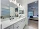 Stylish bathroom featuring a double vanity, a bathtub and a walk-in shower at 7748 Four Seasons Blvd, Kissimmee, FL 34747