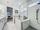 Modern bathroom with a bathtub, walk-in shower with geometric white tile and dual sinks at 7748 Four Seasons Blvd, Kissimmee, FL 34747