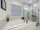 Bathroom with bathtub and frameless shower with geometric white tile at 7748 Four Seasons Blvd, Kissimmee, FL 34747