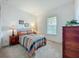 Cozy bedroom with a brightly patterned quilt, side tables with lamps, and a neutral color scheme at 7748 Four Seasons Blvd, Kissimmee, FL 34747
