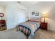 Comfortable bedroom with patterned quilt, side tables with lamps, and closet with sliding doors at 7748 Four Seasons Blvd, Kissimmee, FL 34747