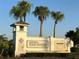 Elegant community entrance sign featuring lush landscaping and distinctive architecture at 7748 Four Seasons Blvd, Kissimmee, FL 34747