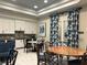 Bright and spacious craft room with ample storage, tables, and a cozy seating area for creative activities at 7748 Four Seasons Blvd, Kissimmee, FL 34747