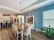 Dining room with a wood table set, blue accent wall, and open access to the kitchen at 7748 Four Seasons Blvd, Kissimmee, FL 34747