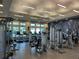 Well-equipped fitness center with modern machines and windows for a bright workout environment at 7748 Four Seasons Blvd, Kissimmee, FL 34747