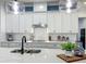 Modern kitchen island with a sink, pendant lighting, ample counter space, and stainless steel appliances at 7748 Four Seasons Blvd, Kissimmee, FL 34747