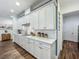Well-equipped kitchen with white cabinets, quartz countertops, stainless steel appliances, and ample counter space at 7748 Four Seasons Blvd, Kissimmee, FL 34747
