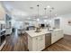 Beautiful kitchen featuring an island with seating, stainless steel appliances, and stylish pendant lighting at 7748 Four Seasons Blvd, Kissimmee, FL 34747