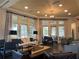 Relaxing living room area with stylish seating, elegant decor, and abundant natural light at 7748 Four Seasons Blvd, Kissimmee, FL 34747