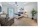 Comfortable main bedroom with ceiling fan, carpet and a view of the pool area at 7748 Four Seasons Blvd, Kissimmee, FL 34747