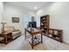 Comfortable home office featuring a wooden desk, chair, bookcase, and a cozy armchair at 7748 Four Seasons Blvd, Kissimmee, FL 34747