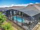 Overhead view of the inviting private pool area with covered lanai and lounge chairs at 7748 Four Seasons Blvd, Kissimmee, FL 34747