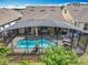 Aerial view of the screened in private pool with lush landscaping and outdoor seating area at 7748 Four Seasons Blvd, Kissimmee, FL 34747