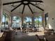 Charming sitting area with comfortable wicker furniture and picturesque views of the pool and palm trees at 7748 Four Seasons Blvd, Kissimmee, FL 34747
