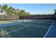 An outdoor tennis court is ready for play with its dark green surface and net at 7748 Four Seasons Blvd, Kissimmee, FL 34747
