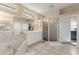 Bright bathroom featuring a soaking tub, glass-enclosed shower, and double vanity at 7867 Horse Ferry Rd, Orlando, FL 32835