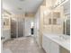 Bathroom with a glass-enclosed shower, double vanity, and tile flooring at 7867 Horse Ferry Rd, Orlando, FL 32835