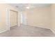 Neutral bedroom with ceiling fan, carpet, closet and connecting door to another room at 7867 Horse Ferry Rd, Orlando, FL 32835