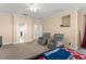 Bedroom showcasing plush seating, neutral walls, and doorway views of the hallway and closet at 7867 Horse Ferry Rd, Orlando, FL 32835