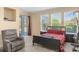 Bedroom with black bed frame, sitting chair, and a sliding glass door leading to the pool area at 7867 Horse Ferry Rd, Orlando, FL 32835