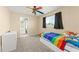 Cheerful bedroom with colorful accents, a ceiling fan, and a window offering natural light at 7867 Horse Ferry Rd, Orlando, FL 32835