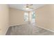 Neutral bedroom with ensuite bathroom, ceiling fan and carpet, great for relaxation at 7867 Horse Ferry Rd, Orlando, FL 32835