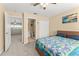 Cozy bedroom featuring a colorful patchwork quilt and ensuite bathroom at 7867 Horse Ferry Rd, Orlando, FL 32835