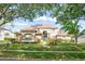 Charming two-story home featuring solar panels, a manicured lawn and blue entry door at 7867 Horse Ferry Rd, Orlando, FL 32835