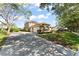 Attractive home with a long driveway, mature landscaping, and a spacious three-car garage at 7867 Horse Ferry Rd, Orlando, FL 32835