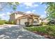 Inviting home with a three-car garage, lush lawn, and meticulously maintained shrubbery at 7867 Horse Ferry Rd, Orlando, FL 32835