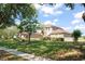 Charming home with a manicured lawn, mature trees, and tasteful landscaping at 7867 Horse Ferry Rd, Orlando, FL 32835