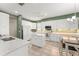 Well-lit kitchen showcasing white cabinetry, stainless steel appliances, granite countertops, and an adjacent dining area at 7867 Horse Ferry Rd, Orlando, FL 32835