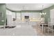 Well-lit kitchen showcasing white cabinetry, stainless steel appliances, granite countertops, and an adjacent dining area at 7867 Horse Ferry Rd, Orlando, FL 32835