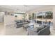 Open living room with neutral colors, access to outdoor pool, and seamless flow to kitchen featuring an eat-in breakfast bar at 7867 Horse Ferry Rd, Orlando, FL 32835