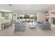 Bright living room featuring neutral walls, plush seating, and sliding glass doors that lead to an outdoor pool area at 7867 Horse Ferry Rd, Orlando, FL 32835